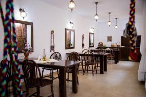 a dining room with wooden tables and chairs at Casa de sub deal in Bîltişoara