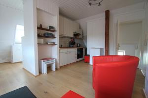 a kitchen with a red chair in a room at Haus Victoria in Marburg an der Lahn