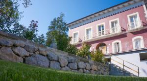 a retaining wall in front of a pink building at Apartamentos Playas de Noja in Noja