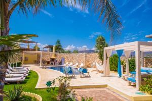 a villa with a swimming pool and a patio at Azzuro Villa with private pool by Estia in Hersonissos