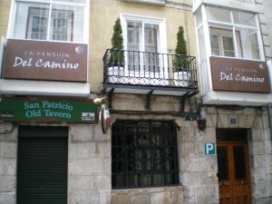 a building that has a sign on the side of it at La Pensión del Camino in Burgos