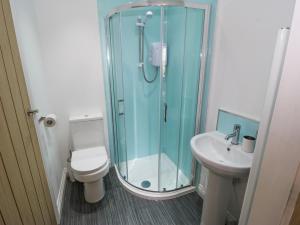 a bathroom with a shower and a toilet and a sink at The Button Box in Huddersfield +15 photos