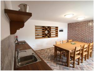 a kitchen and dining room with a wooden table at Apartments Tomas in Primošten