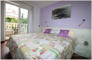 a bedroom with a bed with purple walls and a window at Apartments Tomas in Primošten +151 photos