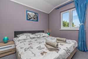 a bedroom with a large bed and a window at Apartment Brzac in Brzac
