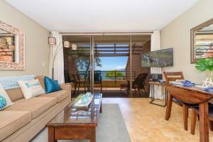 a living room with a couch and a table at Kuleana 713 in Lahaina