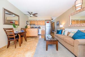 a living room with a couch and a table at Kuleana 713 in Lahaina +29 photos