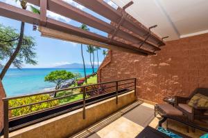 a balcony with a view of the ocean at Kuleana 713 in Lahaina