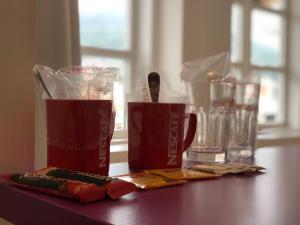 a table with two cups and a drink on it at Guesthouse Biser in Sarajevo