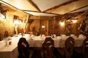 a dining room with a white table and chairs at Hotel Complex Verhovina in Kyiv