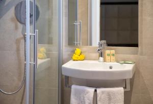 a bathroom with a sink and a shower at Hotel Clara in Riccione