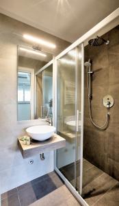 a bathroom with a sink and a shower at Hotel Clara in Riccione