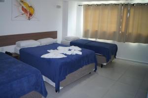 Postel nebo postele na pokoji v ubytování Anjos Praia Hotel
