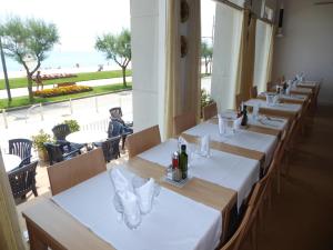 a row of tables in a restaurant with a view of the beach at Hotel Maria Teresa in Sant Antoni de Calonge