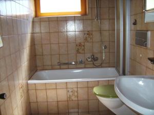 a bathroom with a tub and a toilet and a sink at Haus Michael in Oetz