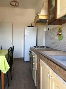 a kitchen with a refrigerator and a table with chairs at Casa vacanze in Terracina