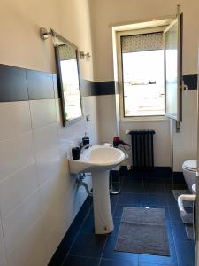 a bathroom with a sink and a toilet at Casa vacanze in Terracina +25 photos
