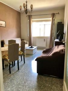 a bedroom with a bed and a table and a window at Casa vacanze in Terracina