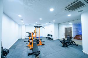 a gym with treadmills and ellipticals and a mirror at Eleana Hotel in Ayia Napa