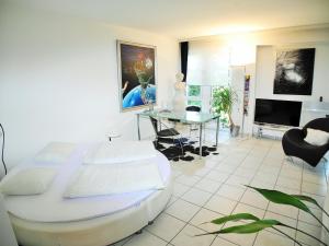 a bedroom with a bed and a table and a television at Apartment Irene - Casa Centro in Ascona