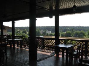 a porch with tables and chairs on a balcony at Hotel Complex Verhovina in Kyiv