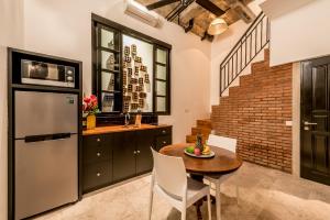 a kitchen with a table and a refrigerator at Villa Kapai in Seminyak
