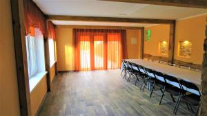 a conference room with a long table and chairs at Pie ābeles in Ventspils