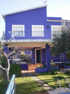 a blue house with a porch and a balcony at La torre in Rodonyà