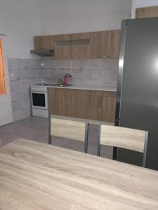 a kitchen with a table and a stainless steel refrigerator at Apartman na namesti in Opočno