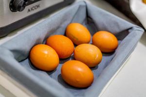 a bunch of oranges sitting in a gray basket at Ossuna Bay Hotel Boutique in Cefalù