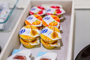a box of sandwiches with oranges and cheese at Ossuna Bay Hotel Boutique in Cefalù