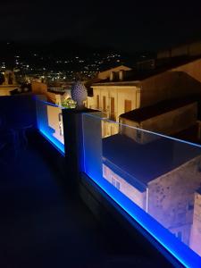 a view of a rooftop at night with blue lights at Ossuna Bay Hotel Boutique in Cefalù