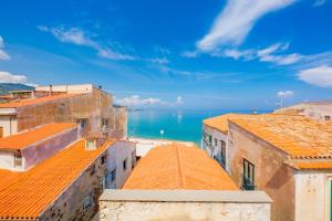 a view of the ocean from the roofs of buildings at Ossuna Bay Hotel Boutique in Cefalù