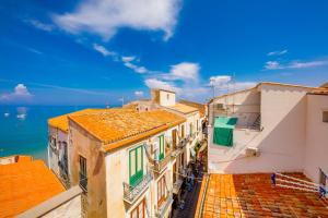 a view of roofs of buildings and the ocean at Ossuna Bay Hotel Boutique in Cefalù