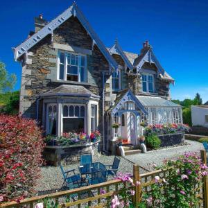 a house with a greenhouse in front of it at Elim Bank Guest House in Bowness-on-Windermere