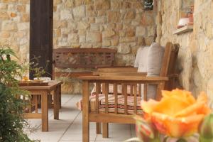 a patio with two tables and a table and chairs at Casa Torreteyera in Villaviciosa