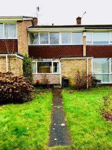 a house with a grass yard in front of it at MyCityHaven - The Chippings - Village life in the city in Bristol