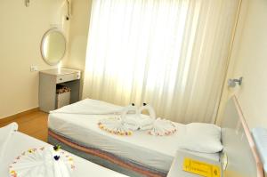 A bed or beds in a room at Magi Apart Hotel