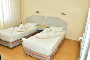 A bed or beds in a room at Magi Apart Hotel