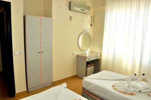 A bed or beds in a room at Magi Apart Hotel
