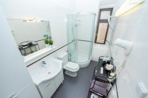 a white bathroom with a toilet and a sink at Cicibela Apartment - Zadar in Zadar +54 photos