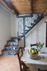 a dining room with a table and a spiral staircase at TRA... INCANTO E NATURA in Tramonti