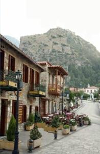 a street with buildings and a mountain in the background at Mystras Inn in Mystras