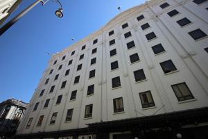 a large white building with a lot of windows at Aristos Puebla in Puebla