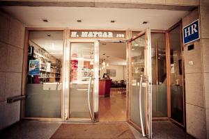 an entrance to a shopping mall with a revolving door at Hotel Maycar in A Coruña