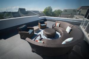 a balcony with a couch and chairs on a roof at The Newport Lofts - 194 Thames Street in Newport