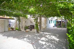 une cour avec des arbres et un trottoir dans l'établissement Apartments Lepur, à Vodice