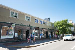 a group of people walking down a street in front of a building at The Newport Lofts - 359 Thames Street in Newport