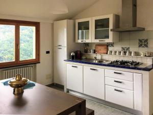a kitchen with white cabinets and a sink and a table at Villa Olivari - apt il Cedro in Camogli +53 photos