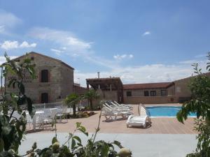 a resort with a swimming pool and a building at El Pilar de Don Gregorio in Pereruela